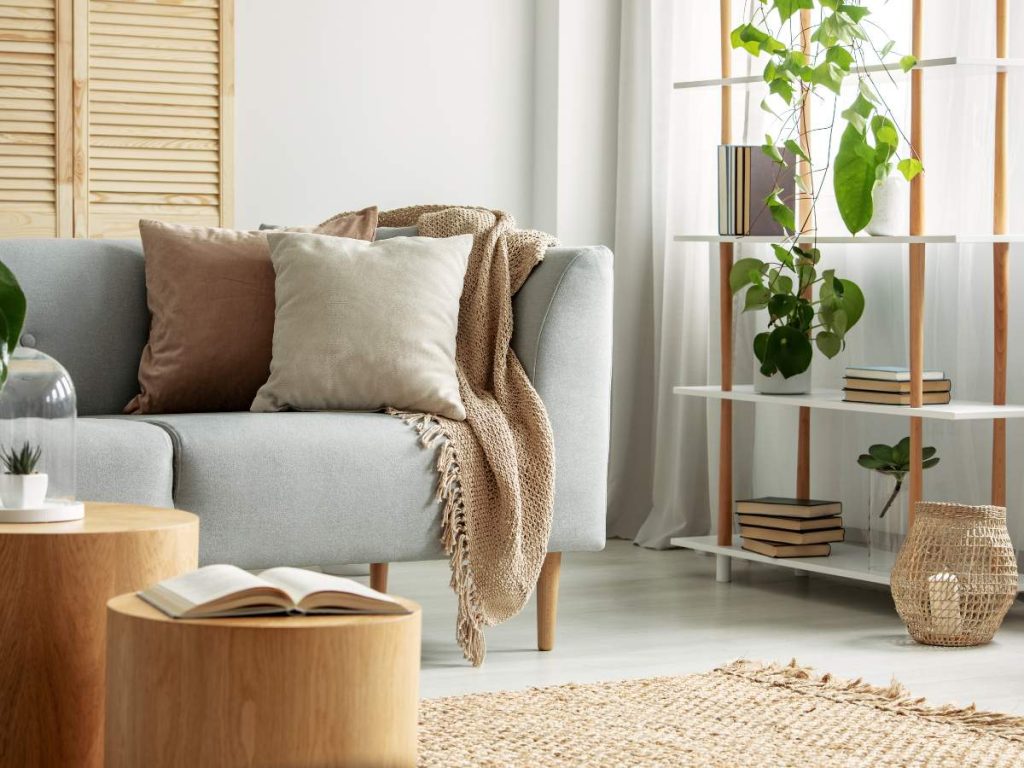 A cozy living room with plush seating, warm lighting, and natural decor elements