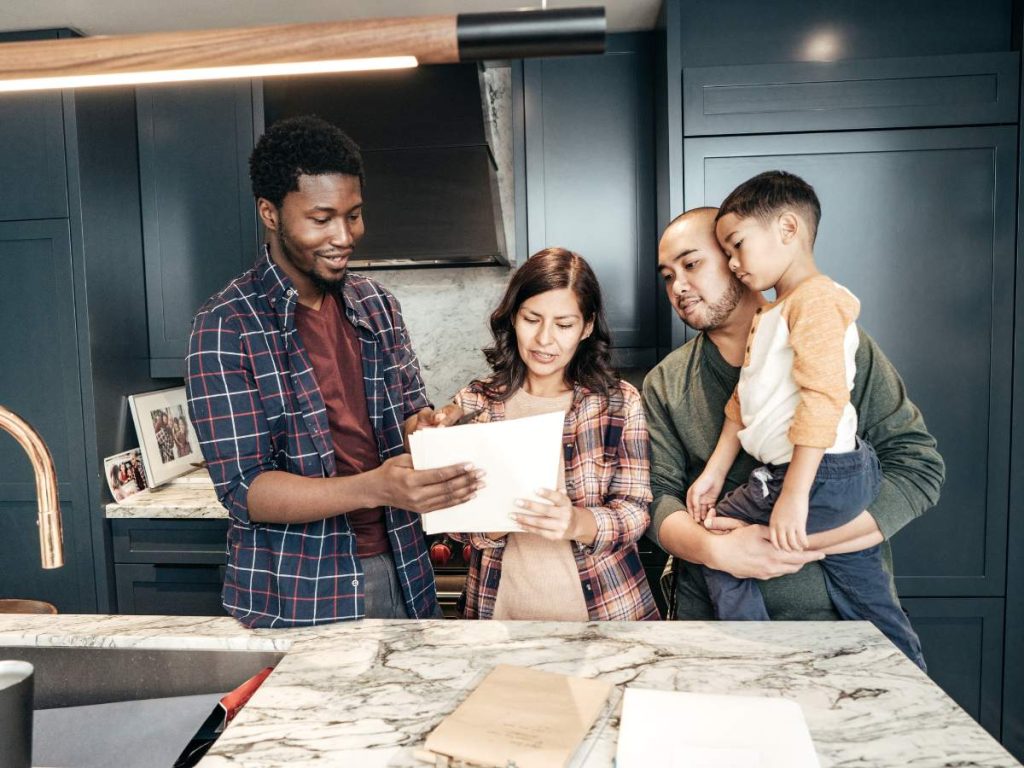 A homeowner reviewing financial documents and remodeling plans at a table